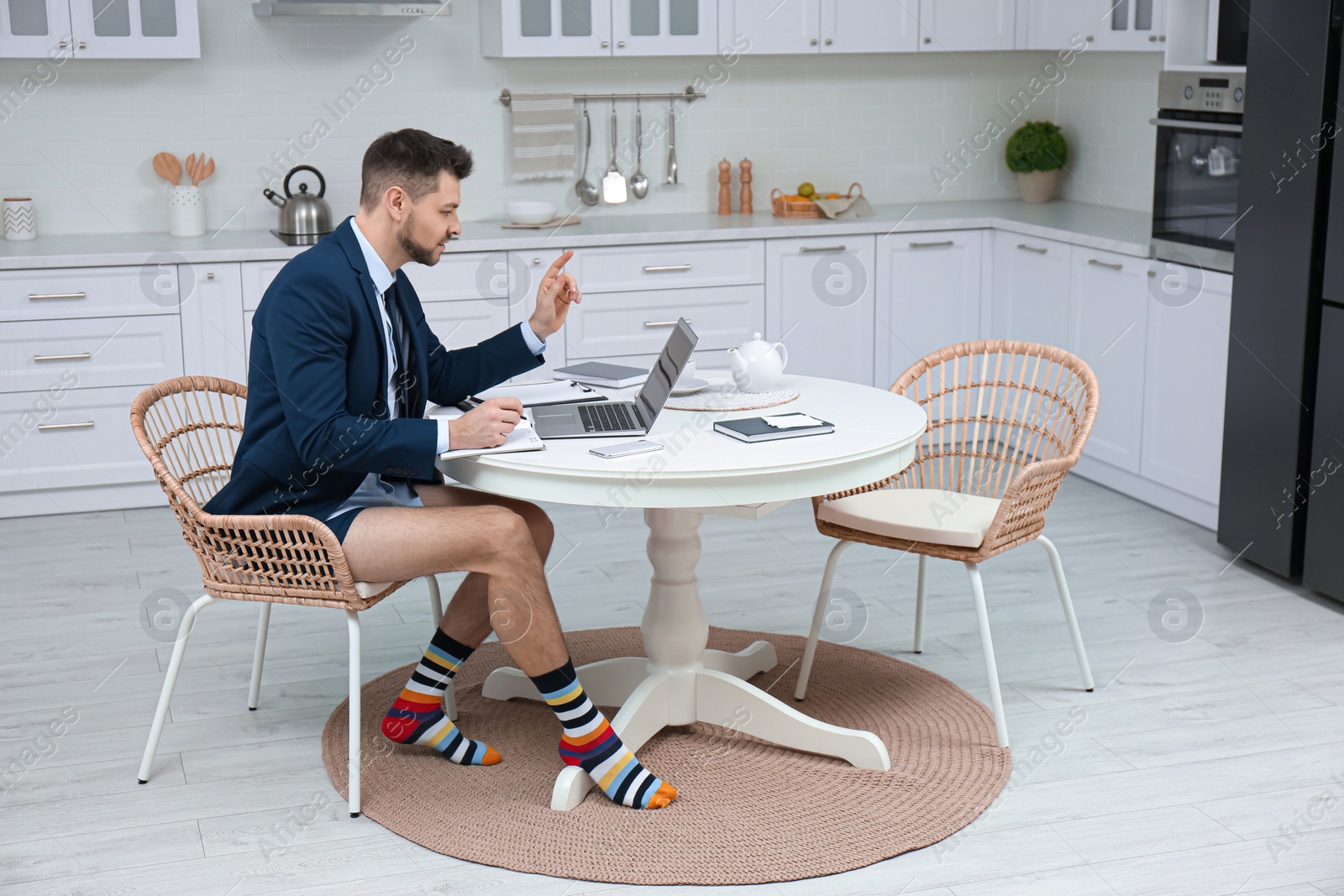 Photo of Businessman in underwear pretending to wear formal clothes during video call at home