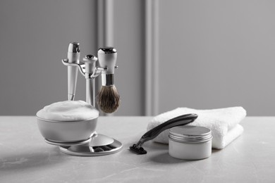 Set of men's shaving tools on grey table