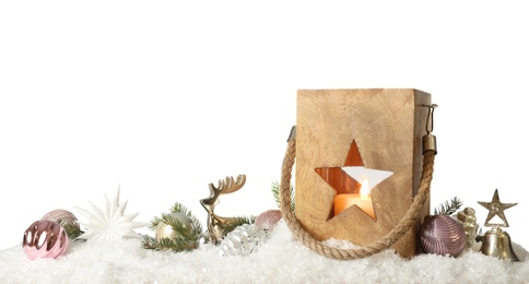 Composition with wooden Christmas lantern on snow against light grey background, space for text