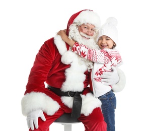 Photo of Little girl hugging authentic Santa Claus on white background