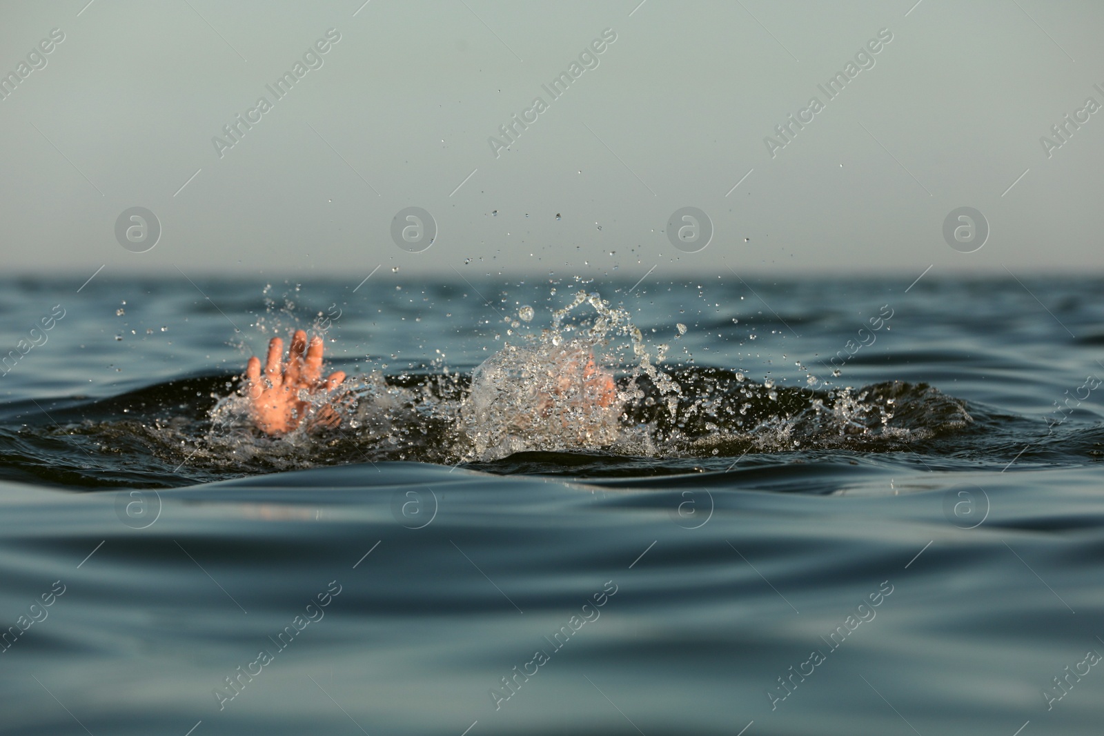 Photo of Drowning man reaching for help in sea