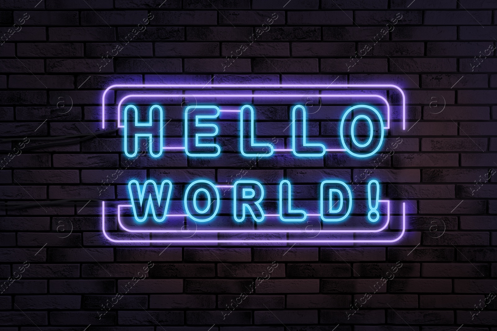 Image of Stylish neon sign with phrase Hello World on brick wall