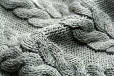 Photo of Knitted fabric with beautiful pattern as background, closeup