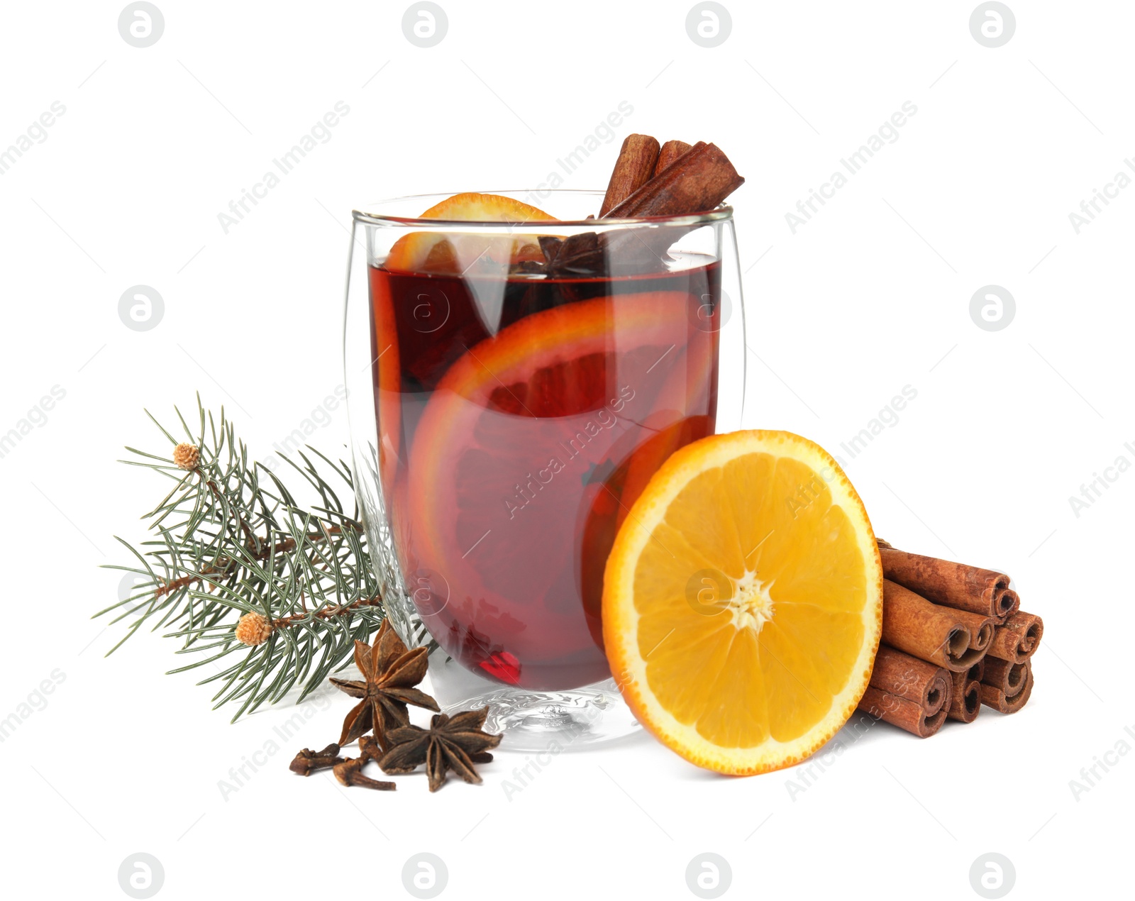 Photo of Glass of mulled wine with fir branch, cinnamon and orange isolated on white