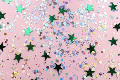 Photo of Shiny glitter on light pink background, flat lay