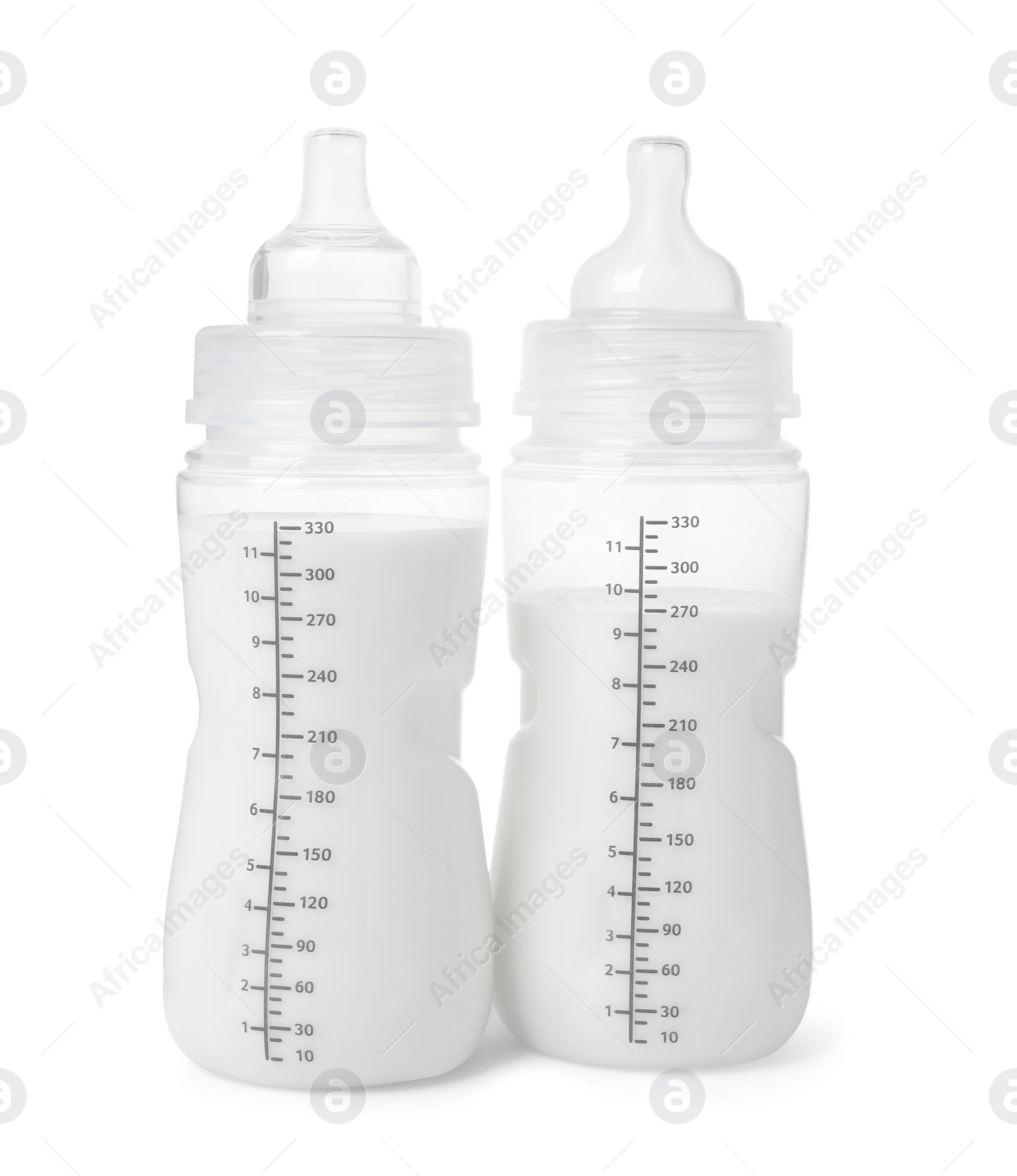 Photo of Two feeding bottles with infant formula on white background