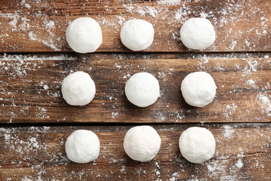 Photo of Round snowballs on wooden background, flat lay