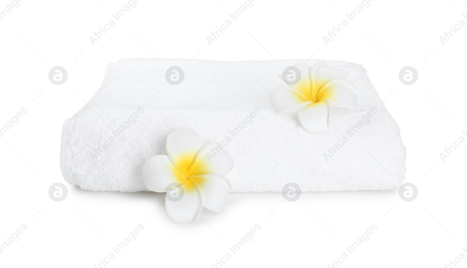 Photo of Terry towel and plumeria flowers isolated on white