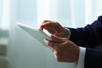 Closeup view of man using new tablet indoors