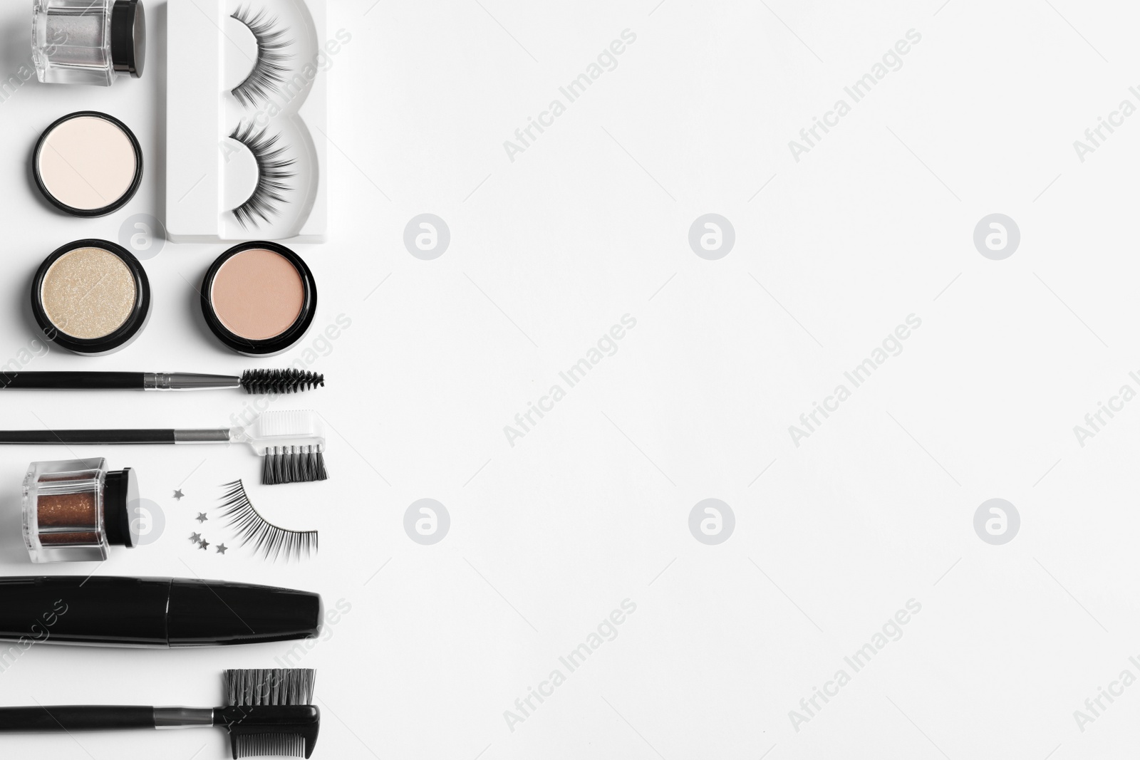 Photo of Composition with false eyelashes and other makeup products on white background, top view