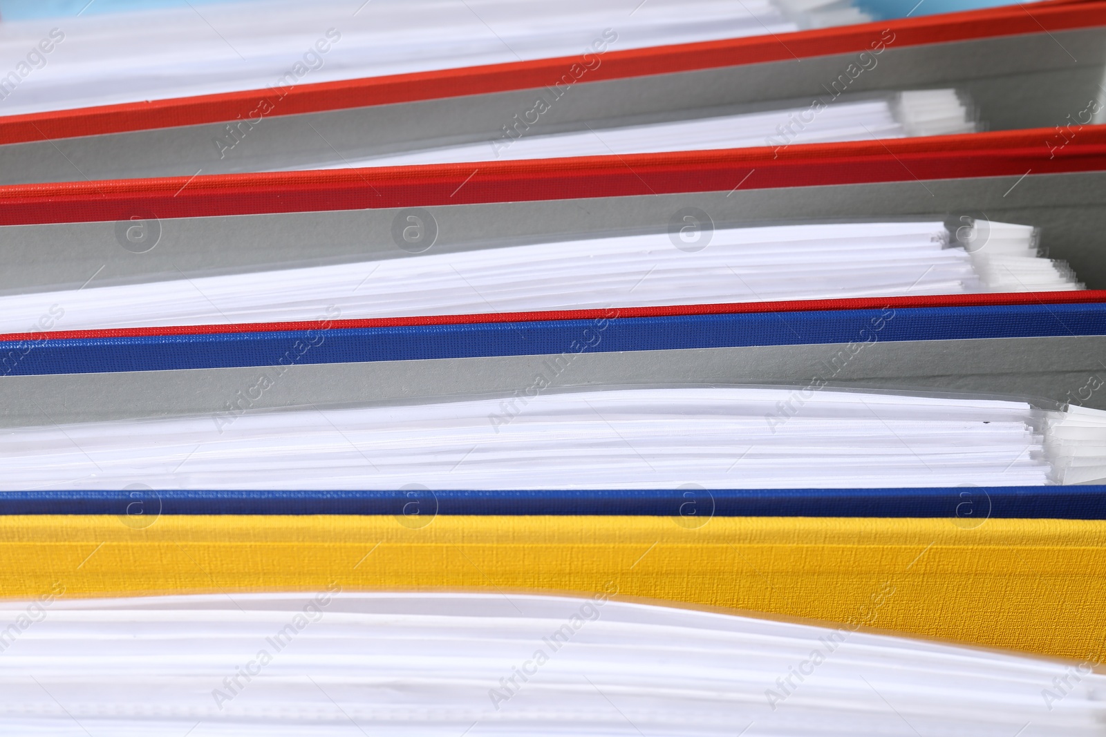 Photo of Colorful binder office folders as background, closeup