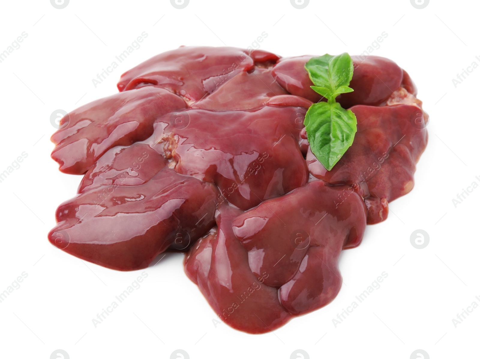 Photo of Pieces of raw chicken liver and basil isolated on white