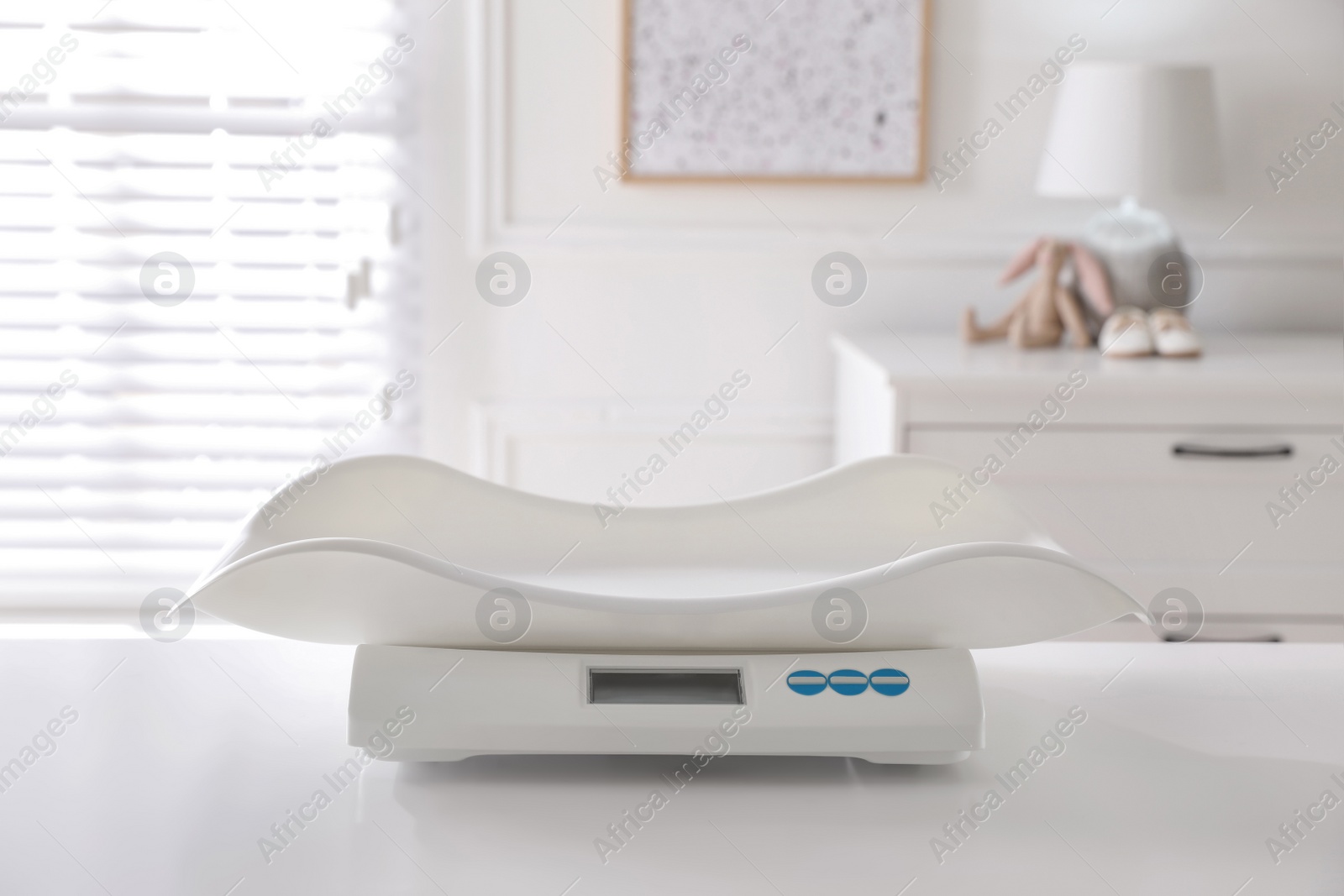 Photo of Modern digital baby scales on table in room