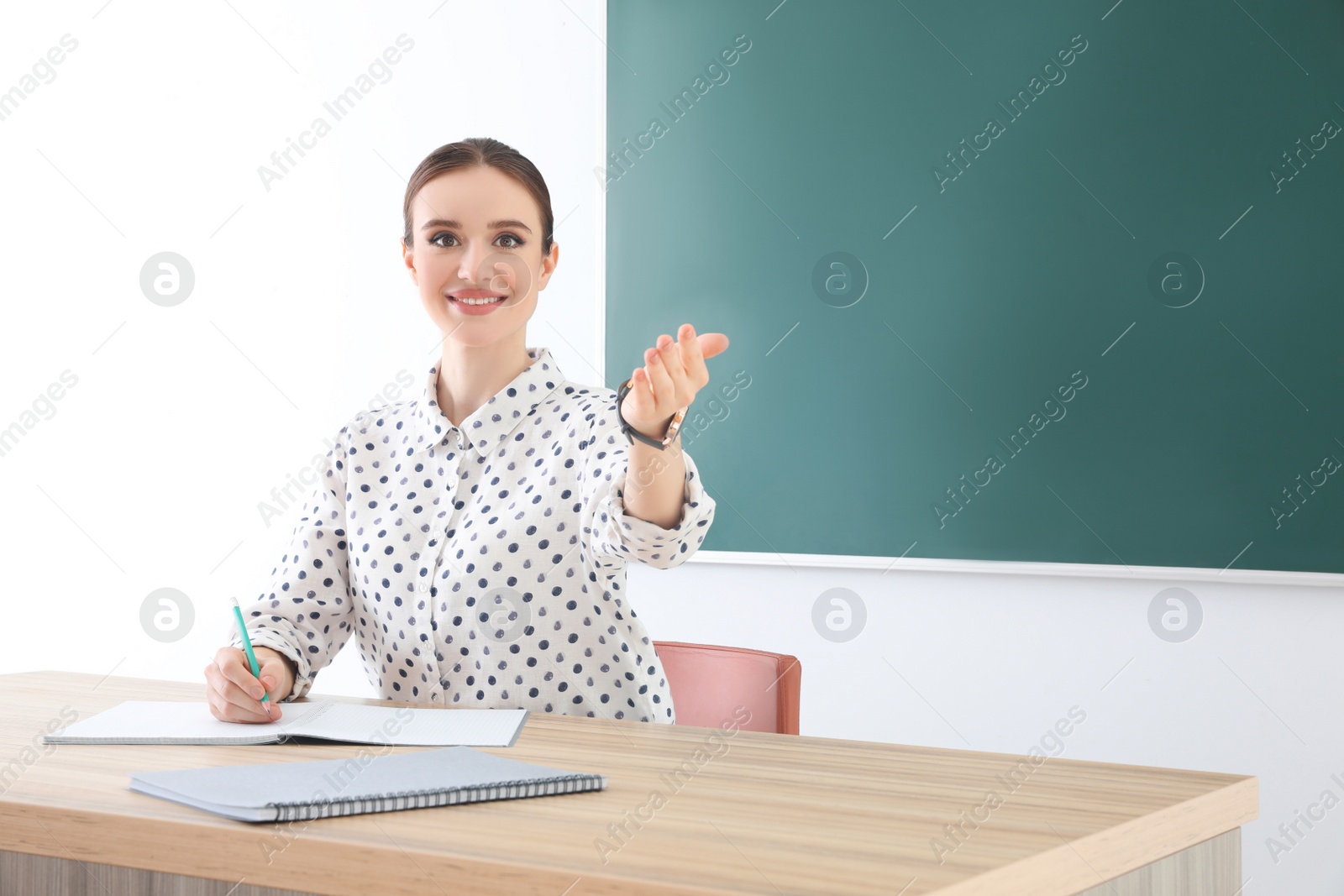 Photo of Portrait of young female teacher in classroom