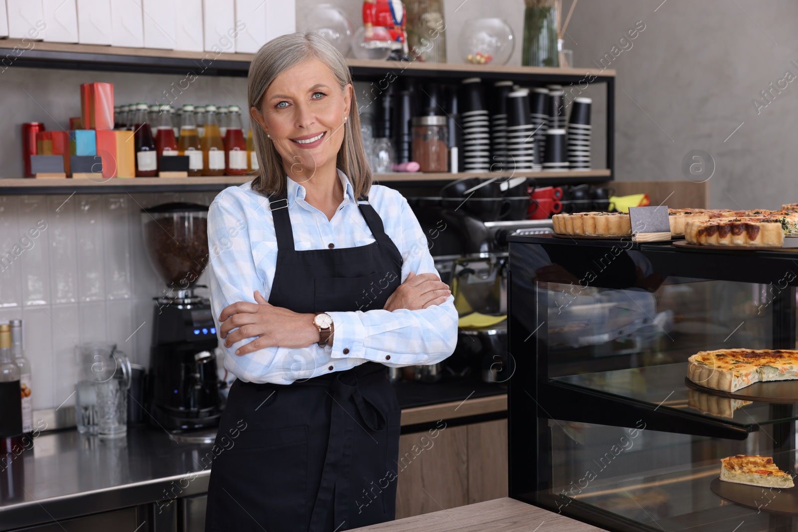 Photo of Portrait of happy business owner in her cafe