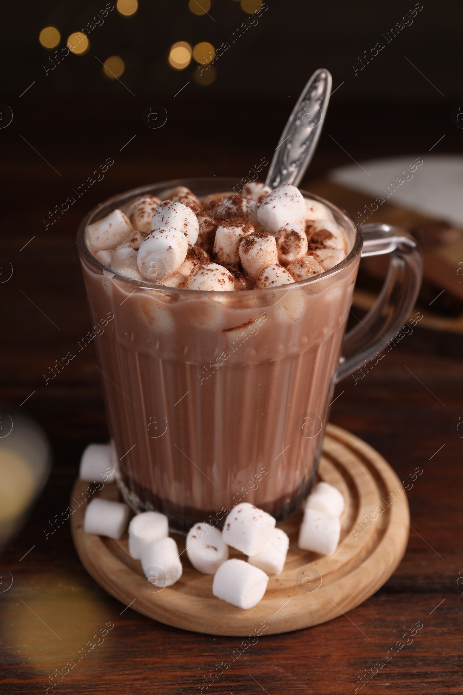 Photo of Cup of aromatic hot chocolate with marshmallows and cocoa powder on table, closeup