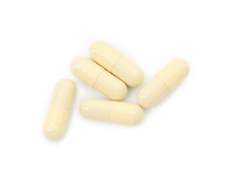 Vitamin capsules isolated on white, top view. Health supplement