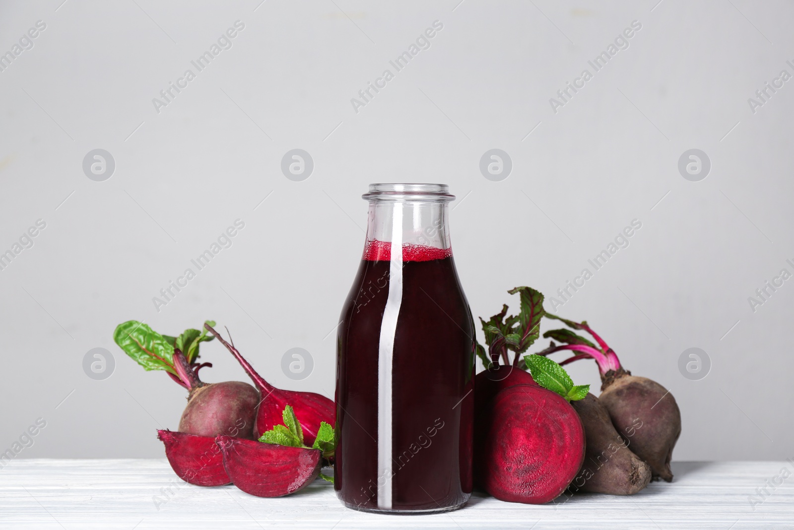 Photo of Freshly made beet juice on grey table