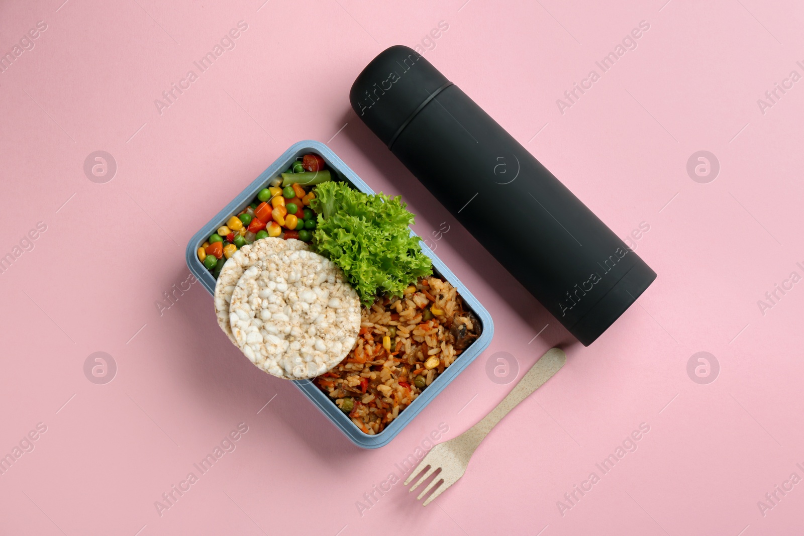Photo of Thermos and lunch box with food on pink background, flat lay