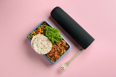 Photo of Thermos and lunch box with food on pink background, flat lay