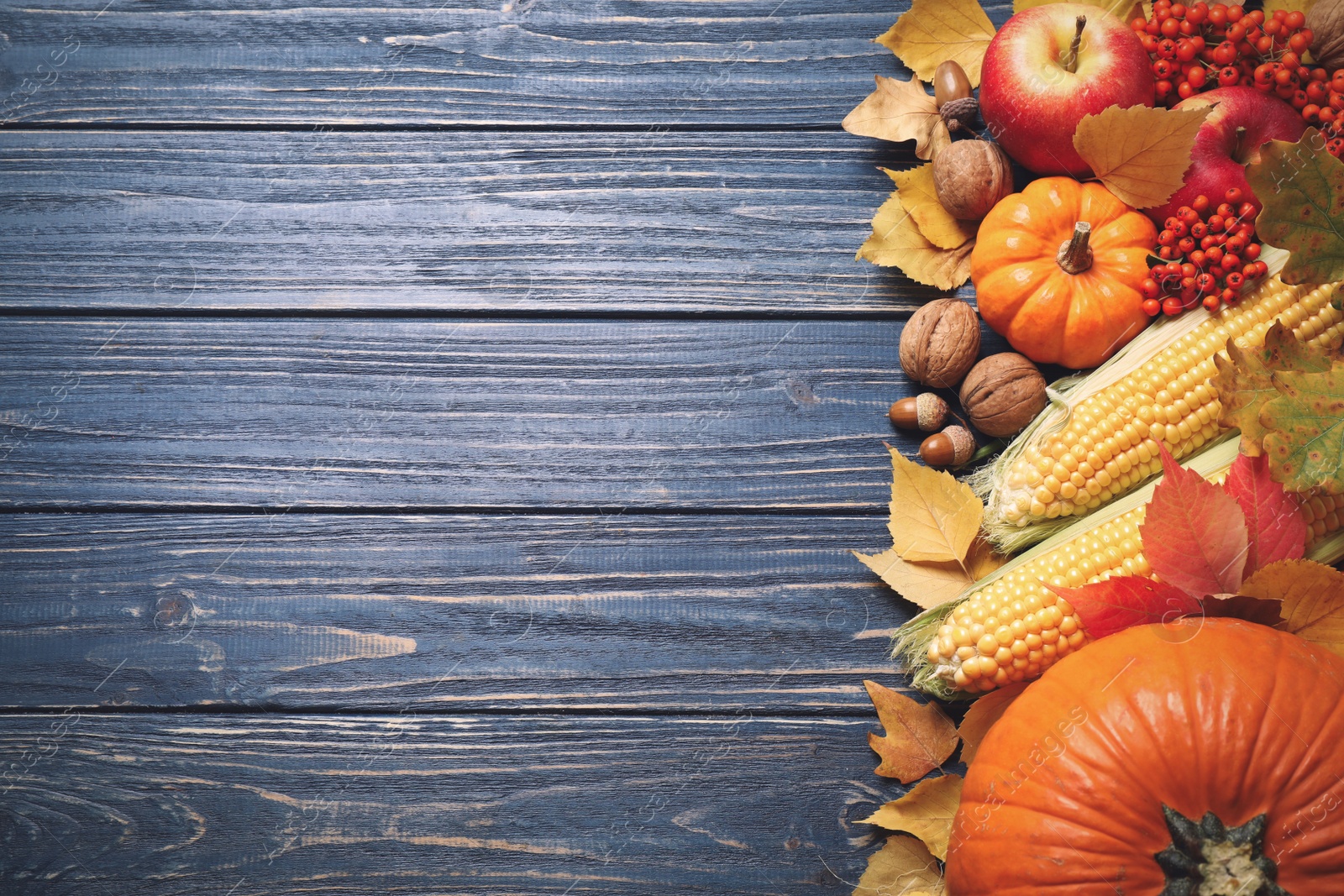 Photo of Flat lay composition with vegetables, fruits and autumn leaves on blue wooden table, space for text. Thanksgiving Day