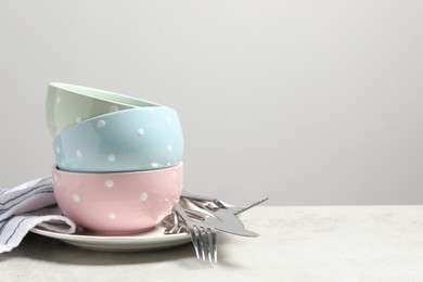 Photo of Beautiful ceramic dishware and cutlery on light grey table, space for text