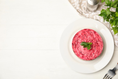 Photo of Herring under fur coat served on white wooden table, flat lay with space for text. Traditional russian salad