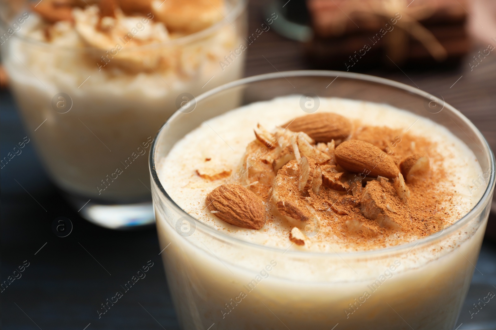 Photo of Delicious rice pudding with almonds and cinnamon, closeup