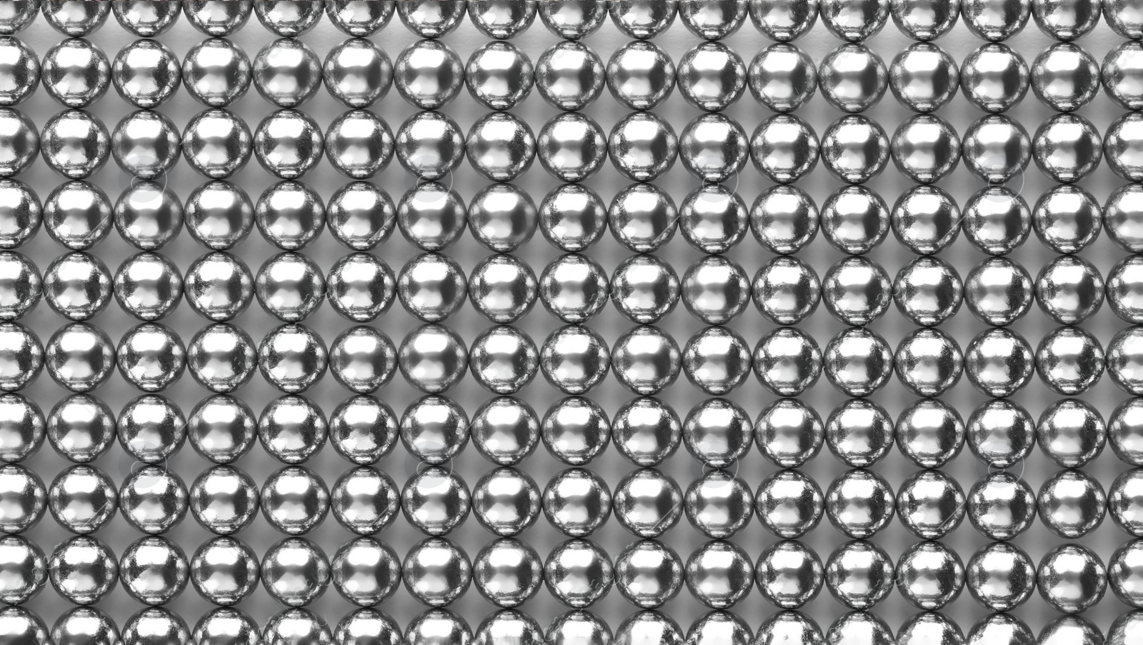 Photo of Small metal magnetic balls as background, top view