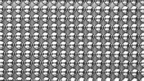 Photo of Small metal magnetic balls as background, top view