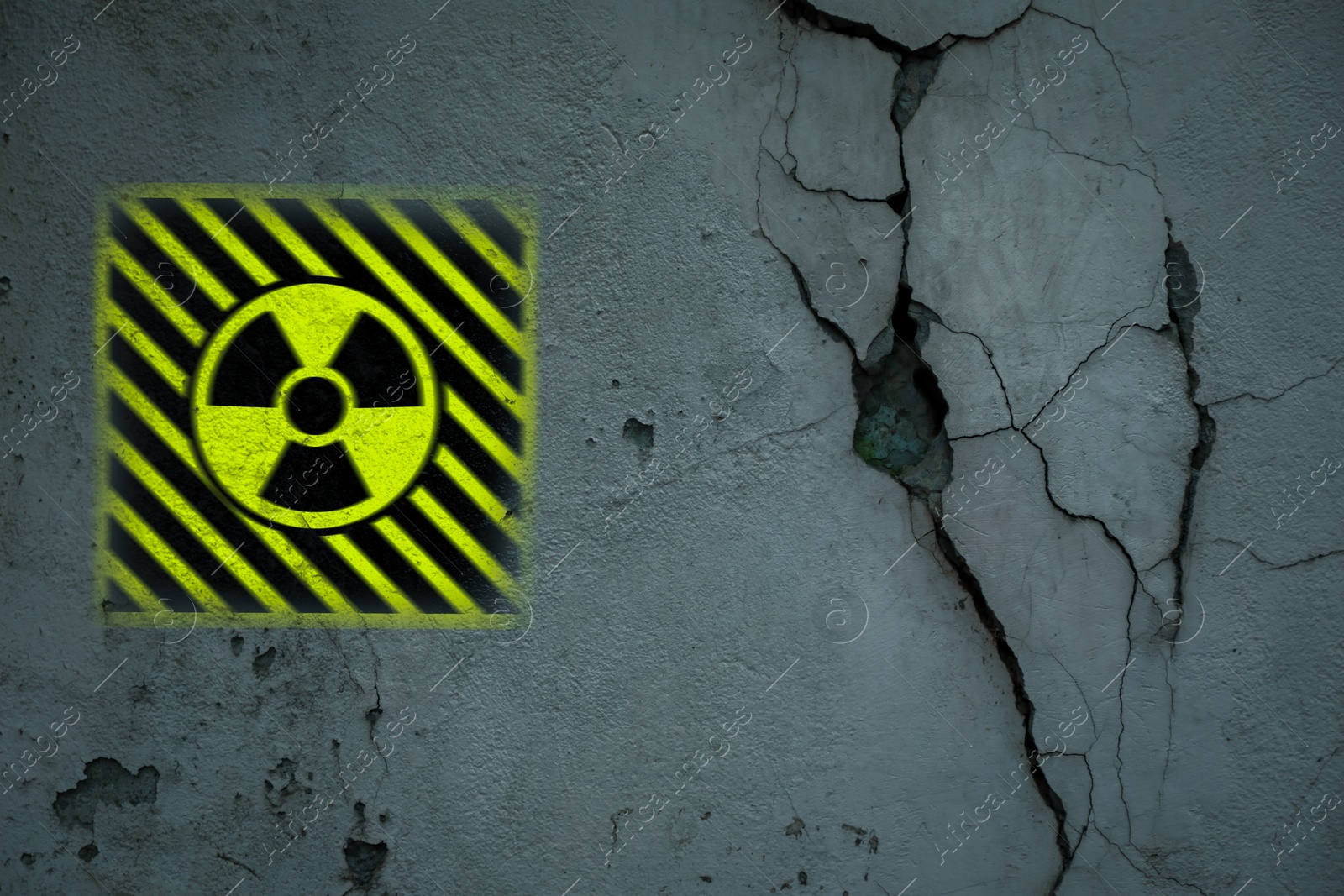 Image of Radioactive sign on old cracked wall. Hazard symbol