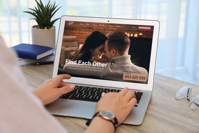 Looking for partner. Woman using laptop at table, closeup. Dating site webpage on device screen