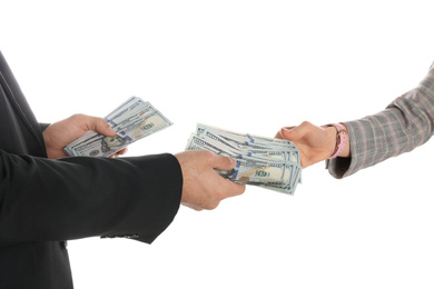 Man giving bribe money to woman on white background, closeup of hands