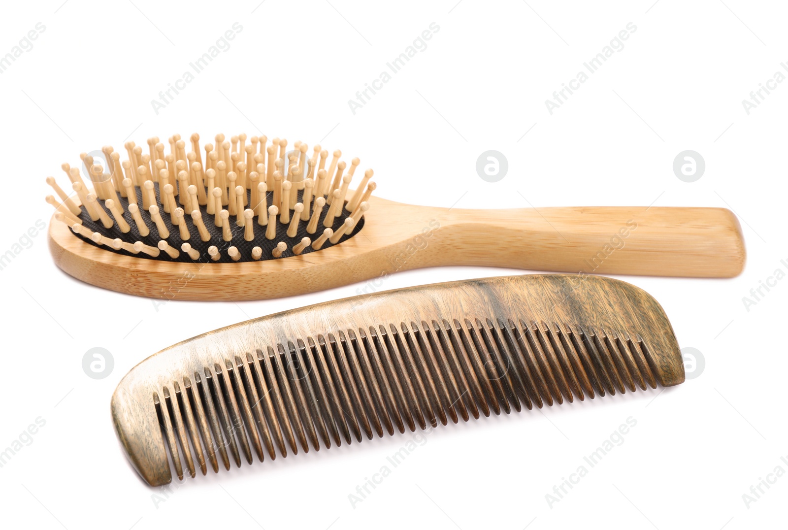 Photo of New wooden hair brush and comb isolated on white