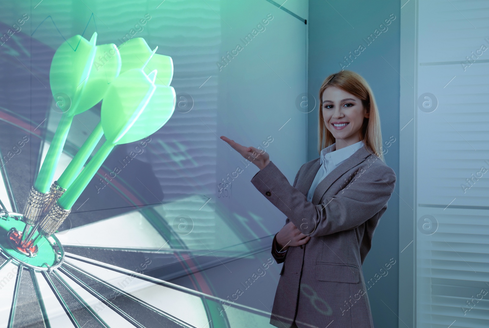 Image of Young businessman in office and dart board with arrows. Double exposure