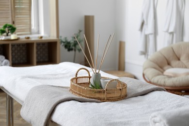 Photo of Beautiful spa accessories on massage table in salon