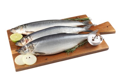 Wooden board with salted herrings, onion, lime, spices and rosemary isolated on white