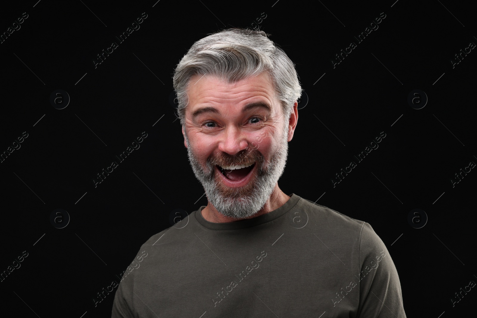 Photo of Personality concept. Portrait of emotional man on black background