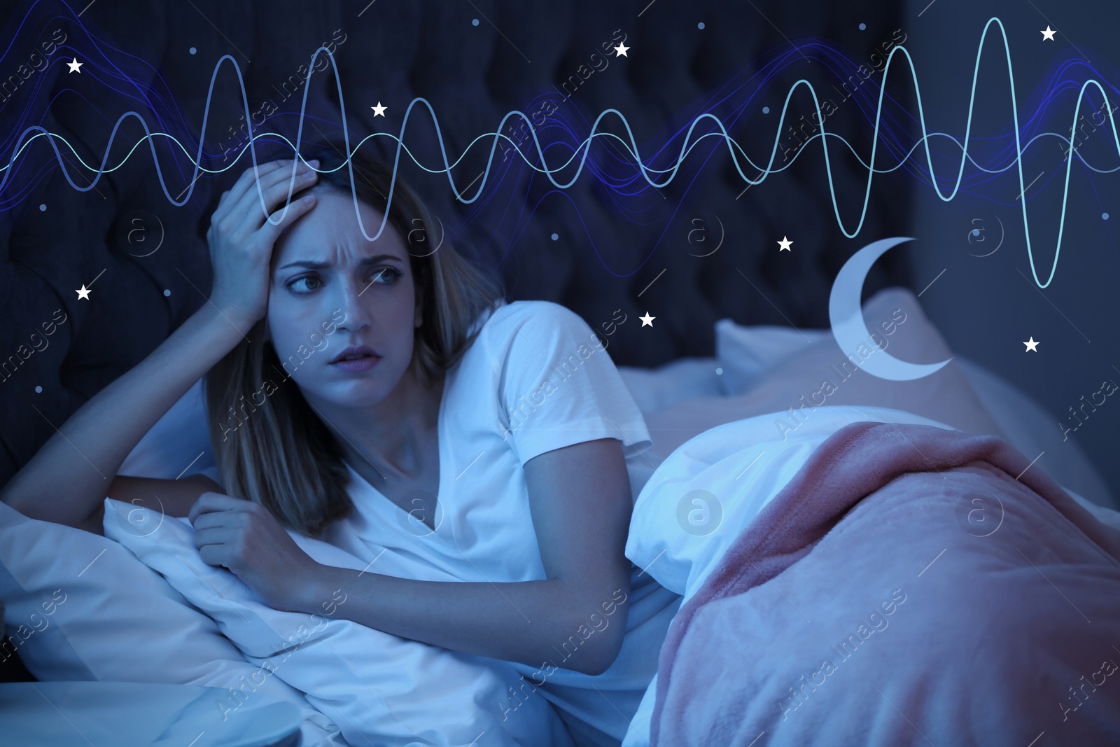 Image of Young woman suffering from insomnia in bed at night. Problem of sleep deprivation