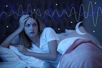 Image of Young woman suffering from insomnia in bed at night. Problem of sleep deprivation