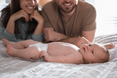 Happy couple with their newborn baby at home