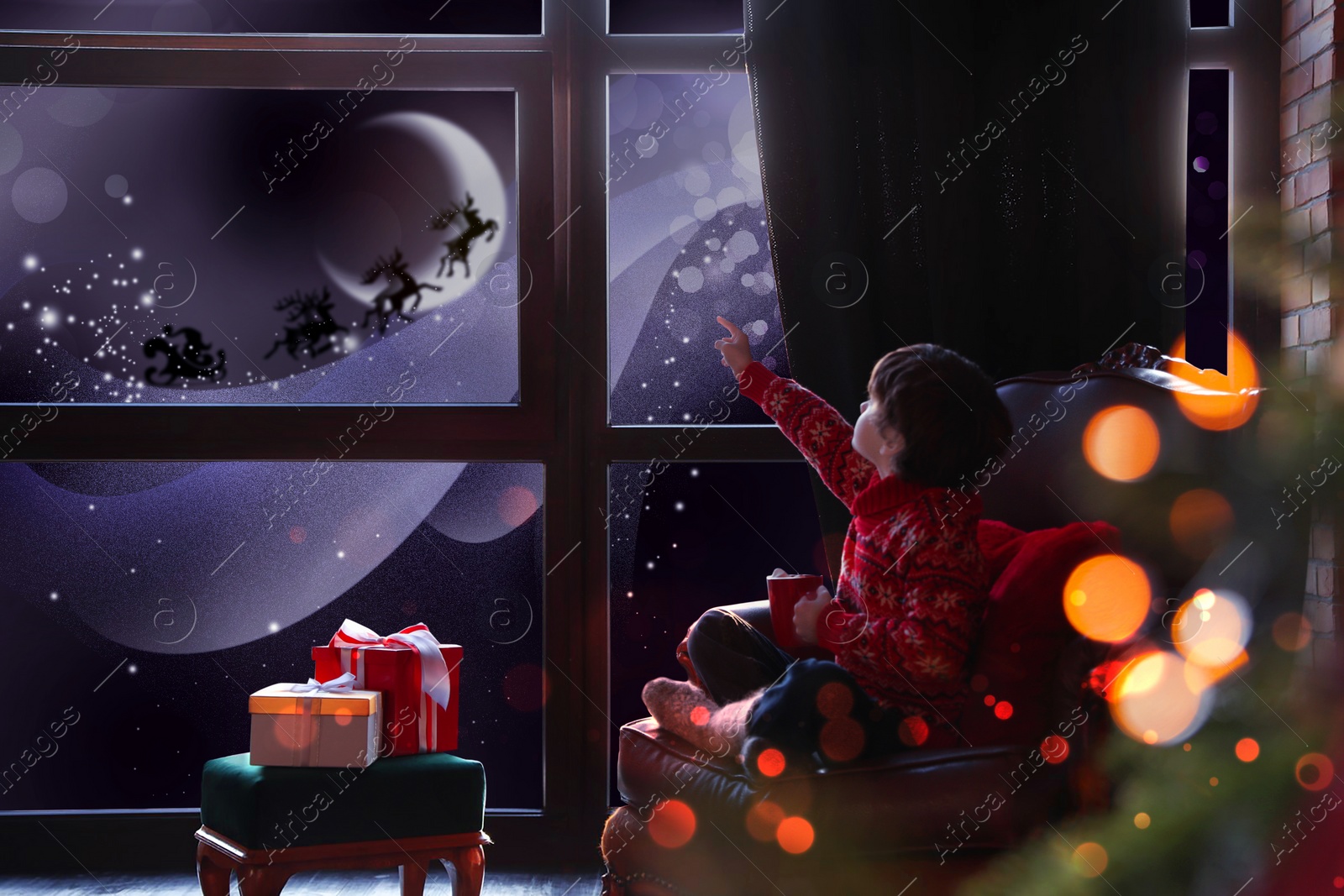 Image of Cute little boy waiting for Santa Claus near window at home. Christmas holiday