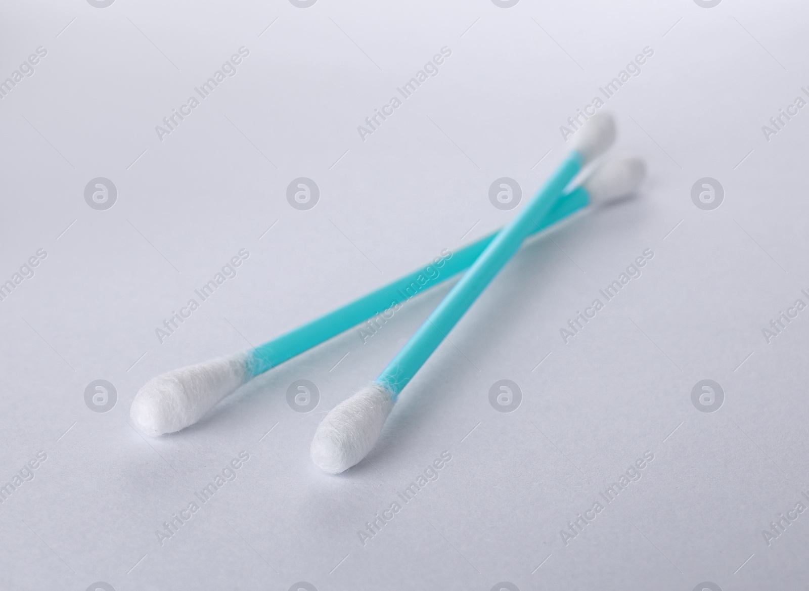 Photo of Clean cotton buds on white background. Hygienic accessory