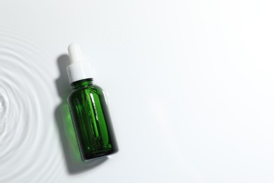 Bottle of cosmetic product on white background, top view. Space for text