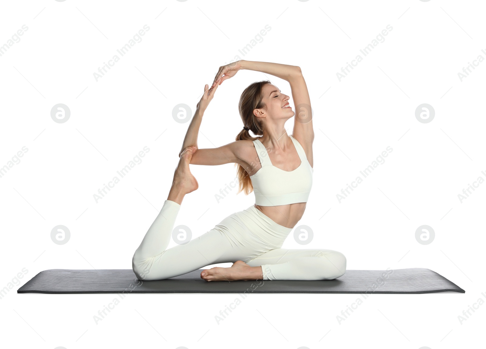 Photo of Young woman in sportswear practicing yoga on white background