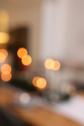 Photo of Blurred view of festive table setting and beautiful Christmas decor indoors