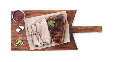 Photo of Pieces of tasty baked pork belly and sauce isolated on white, top view