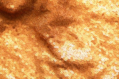 Beautiful golden shiny cloth with sequins as background, top view