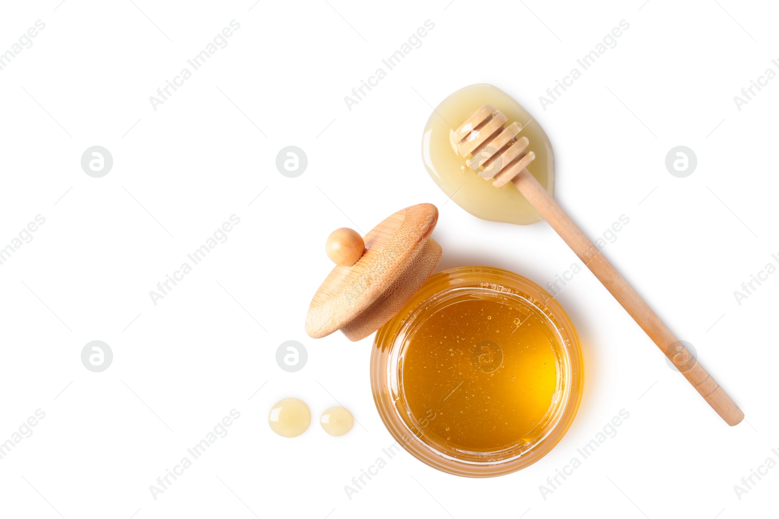 Photo of Tasty honey in glass jar and dipper on white background, top view. Space for text