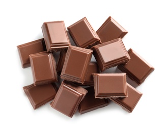 Photo of Pieces of tasty milk chocolate on white background, top view